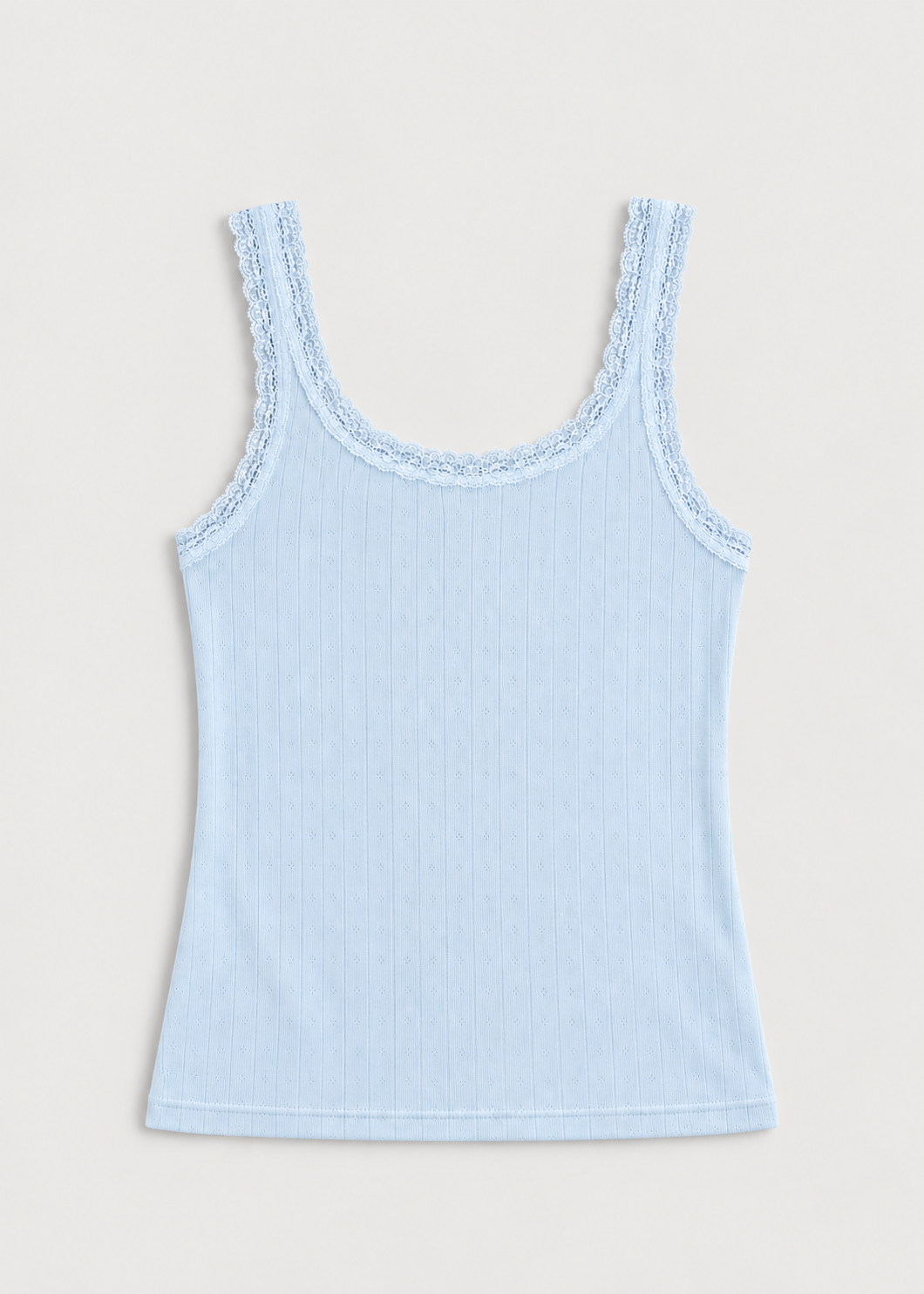 The Betty Singlet - Glacier Blue by Juem laid flat on a pale background, a relaxed pointelle knit tank with a scooped neckline and delicate lace trim at the neckline and armholes.
