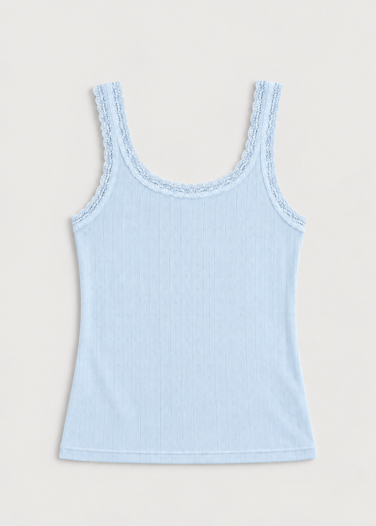 The Betty Singlet - Glacier Blue by Juem laid flat on a pale background, a relaxed pointelle knit tank with a scooped neckline and delicate lace trim at the neckline and armholes.