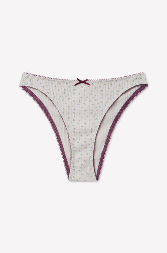 Lera Brief - Blue Floral by 0 features a flattering high cut fit inspired by 90s briefs, adorned with delicate blue floral patterns, elegant lace trim, and a charming bow detail at the front center for a nostalgic yet modern look.