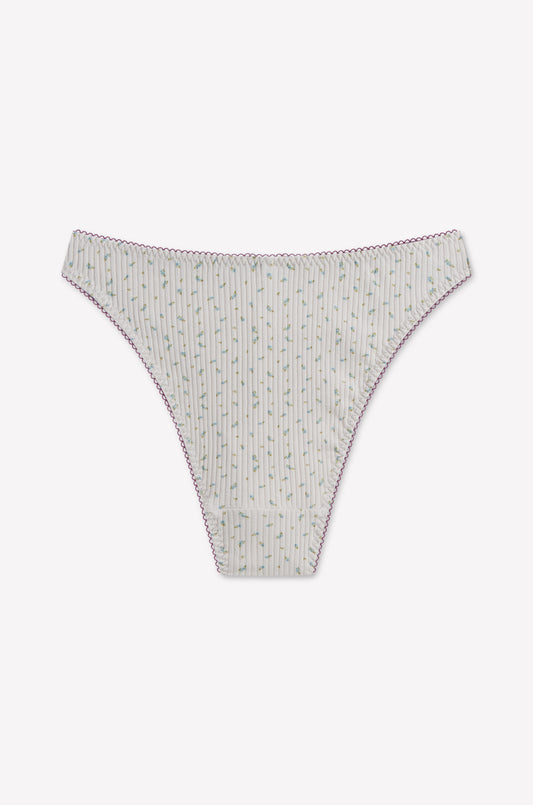 Lera Brief - Blue Floral by 0, a bikini-style underwear featuring a blue floral pattern and pink stitching along the edges, is displayed flat on a white background. This cheeky coverage brief offers a high-cut fit inspired by classic 90’s style, combining retro charm with modern comfort.
