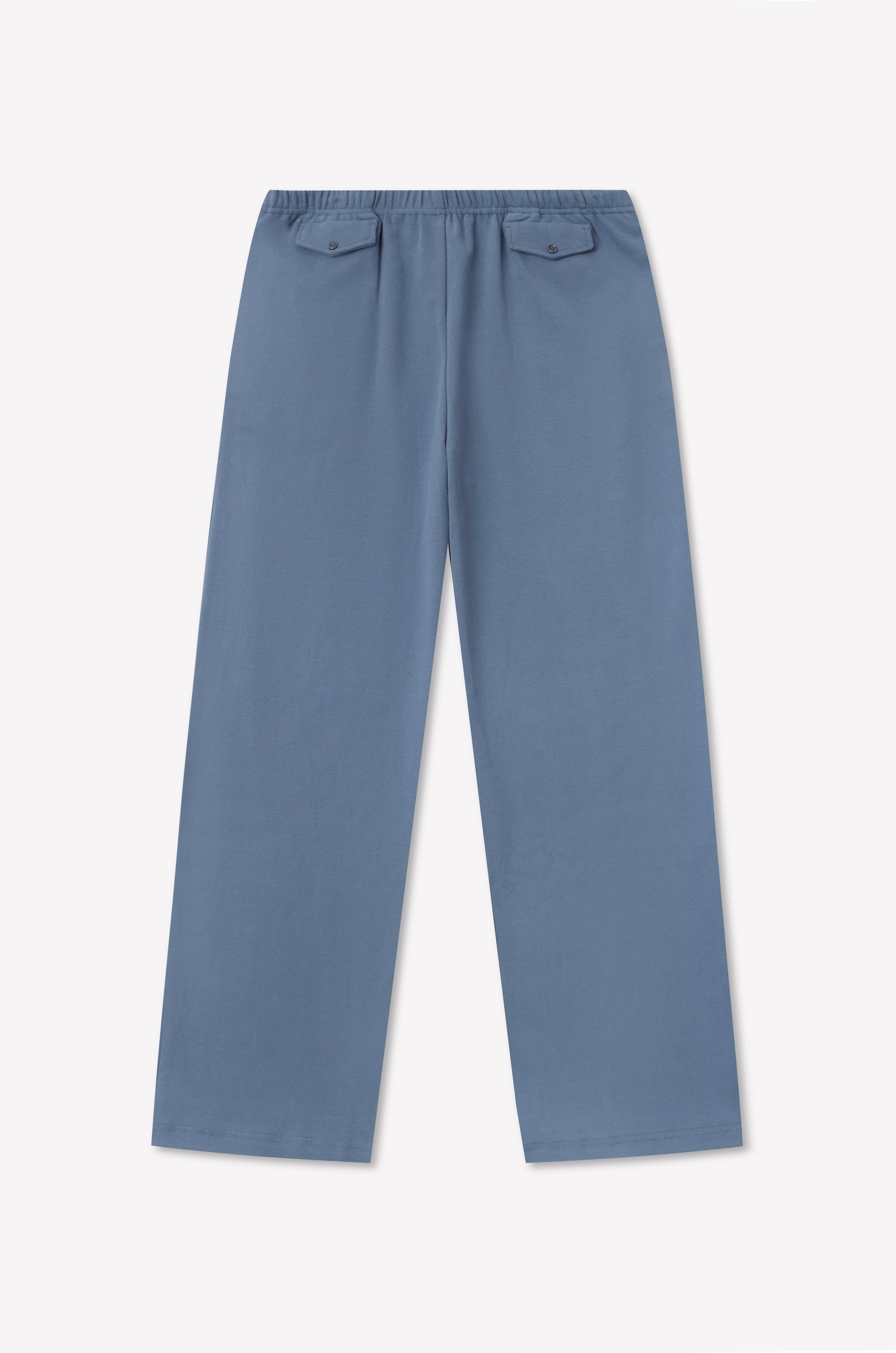 The Vera Track Pant - Sea Blue by 0 features a relaxed fit, an elastic waistband, and two buttoned back pockets, laid flat on a white background.