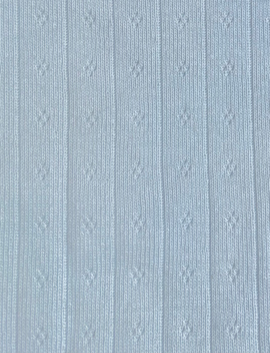 A close-up of the Betty Singlet - Glacier Blue by Juem, showing the pale blue pointelle knit with its fine openwork detail.
