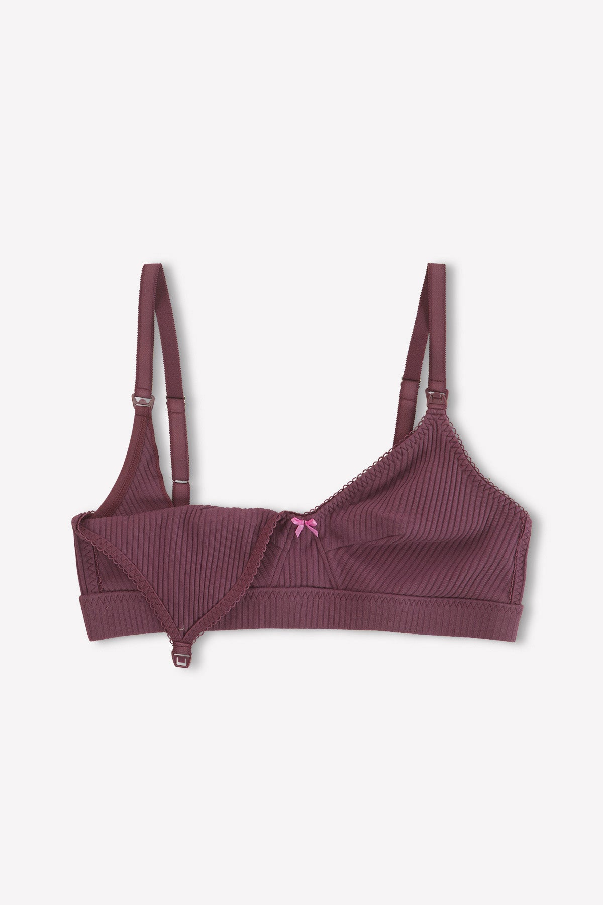 The Paloma Maternity Bra - Plum by 0 is a mauve, ribbed organic cotton bra with adjustable straps, nursing clips, an open cup on one side, and a pink center bow.