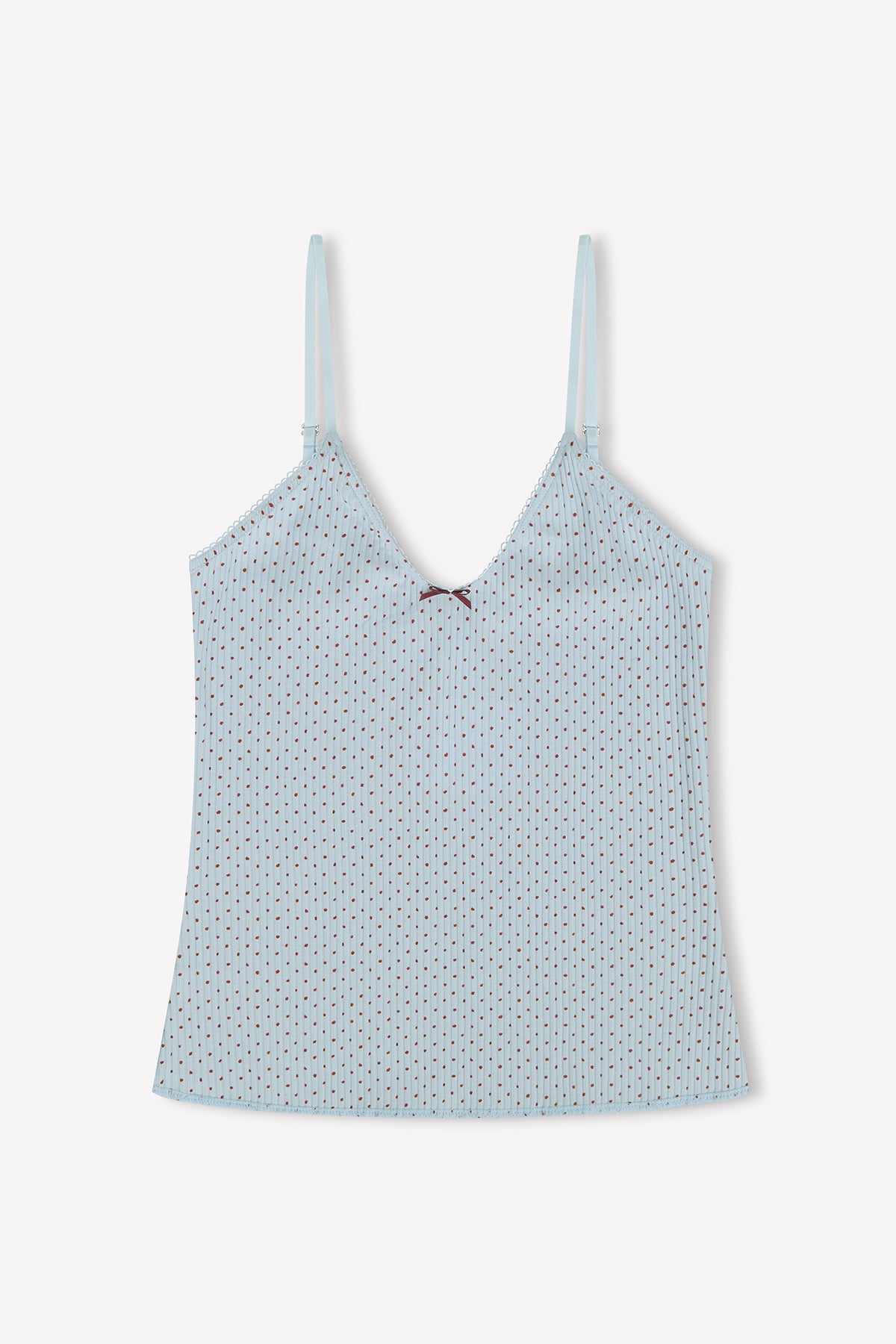 Margot Tank - Polka by 0: Light blue camisole with adjustable straps, subtle polka dots, scalloped edges, and a small burgundy bow at the center neckline, shown on a white background.