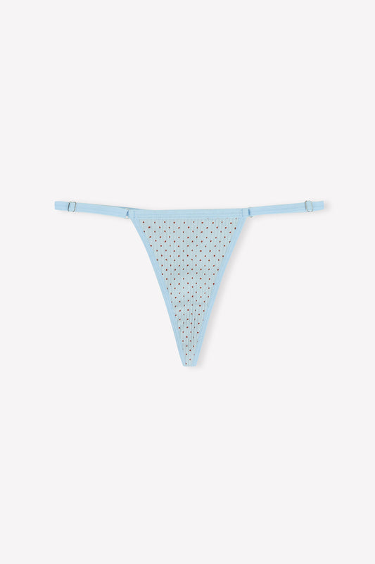 The Harri G String - Polka by 0 is a light blue thong with thin adjustable side straps and a sheer, rhinestone-detailed front, shown against a plain white background.