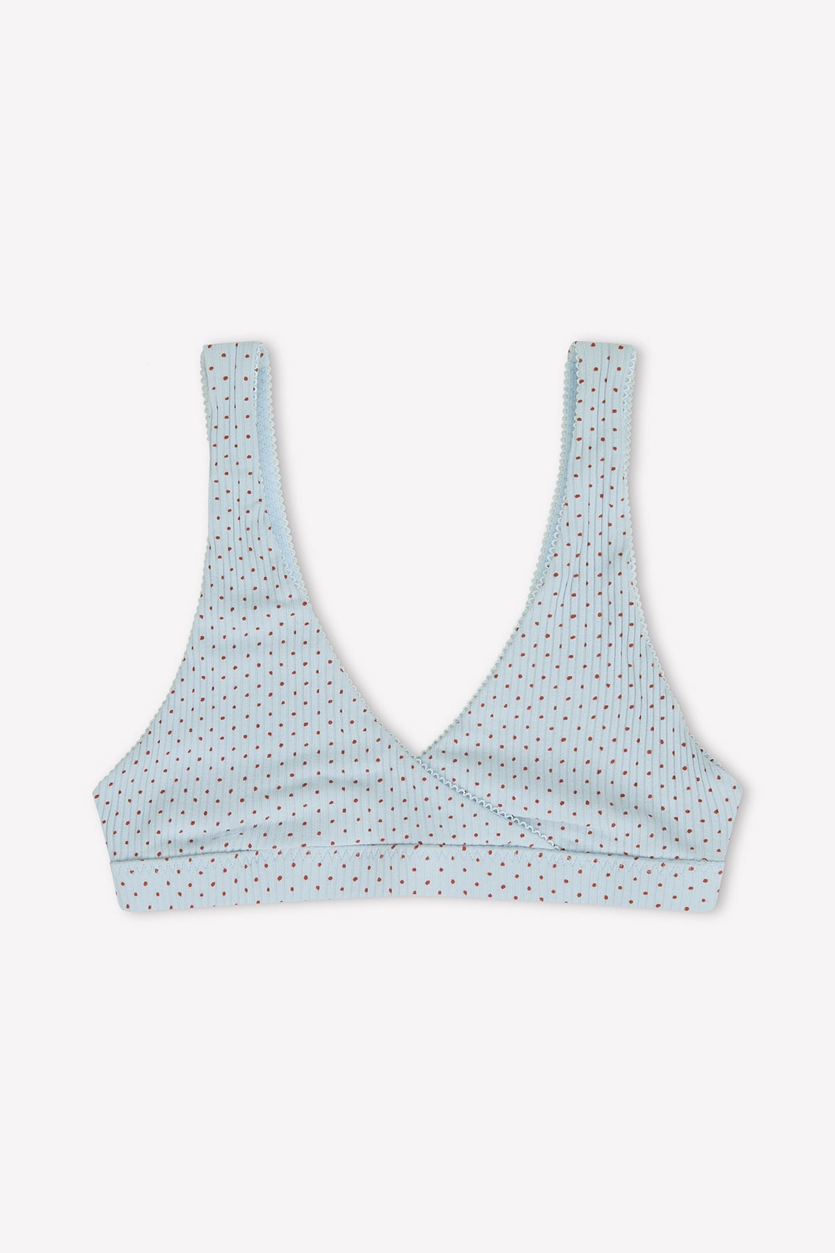The Bernie Bra - Polka by 0 is a light blue, unpadded triangle bra with a deep V-neckline, thin straps, and features subtle rows of multicolored polka dots for simple style.
