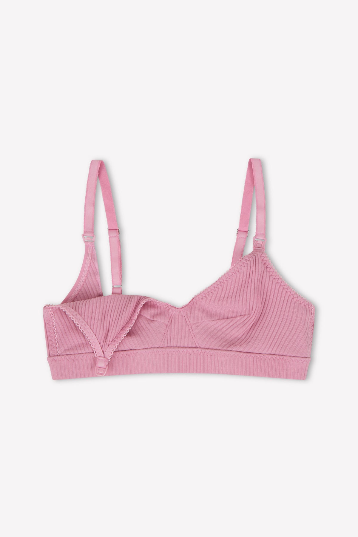 The Paloma Maternity Bra - Fuchsia by 0 is a pink ribbed nursing bra with adjustable straps and a fold-down cup panel for easy nursing, shown on a white background.