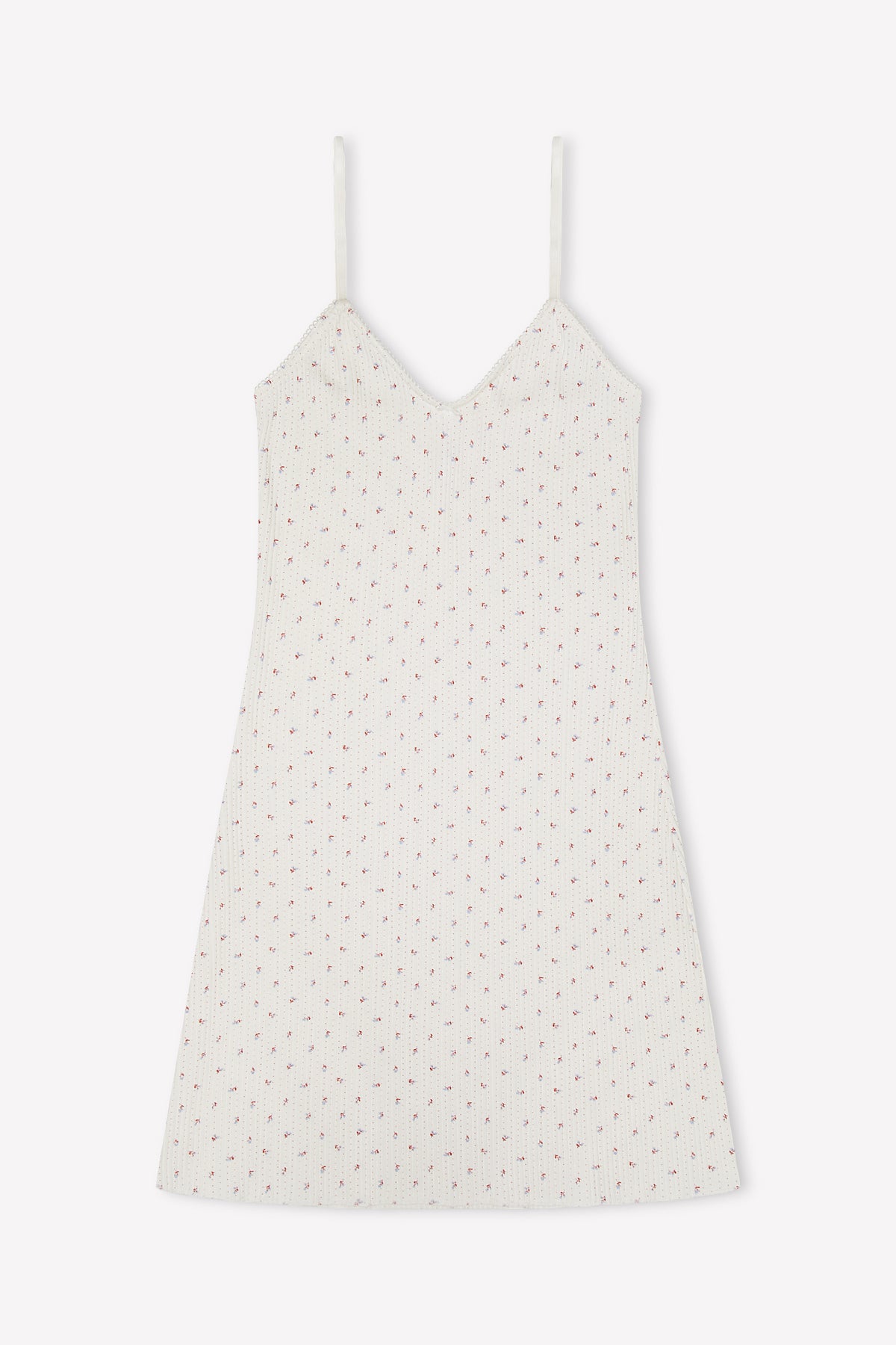 The Lola Mini Dress - Flora is a sleeveless white mini dress with thin straps and a delicate pink floral pattern, shown on a plain white background—ideal for breezy summer days.