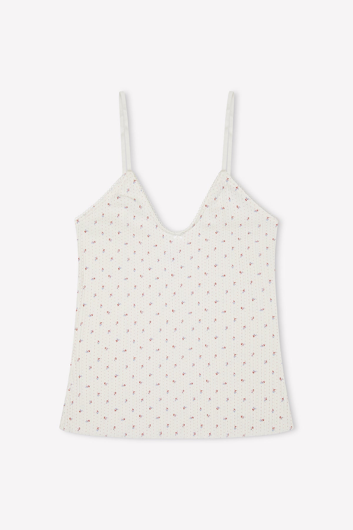 The Margot Tank - Flora is a white ribbed camisole made from organic cotton, with thin adjustable straps and a delicate all-over print of small pink flowers, shown against a plain white background.