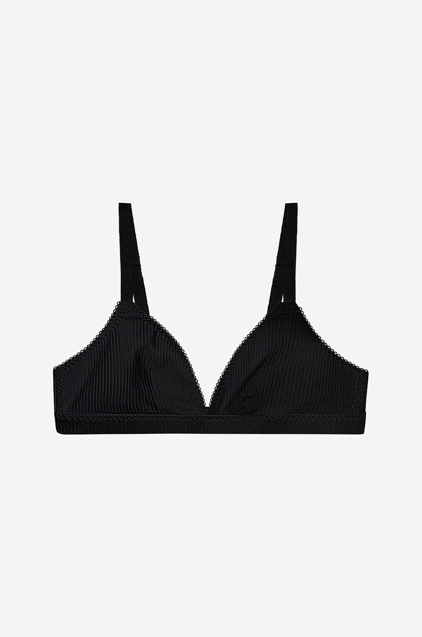 The juem Ines Bra in black features thin, adjustable straps and a ribbed texture, designed as an everyday essential and showcased against a plain white background.
